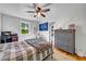 Bedroom features a ceiling fan, sports decor, and hard wood floors at 161 Amy Ln, Canton, GA 30115