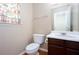 Compact half-bath with floral curtains and a white vanity at 269 Cottonwood Creek Cir, Canton, GA 30114