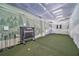 Indoor golf simulator room with turf, netting, and equipment; perfect for practice and recreation at 2950 Mount Wilkinson Se Pkwy # 505, Atlanta, GA 30339