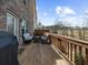 Wooden patio area features outdoor seating, a grill, and views of the backyard and blue skies at 2478 Georgetown Ave, Atlanta, GA 30345