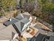 An aerial view of a home with a dark roof and white window panes near a curve in the road at 105 Ivey Way, Woodstock, GA 30188