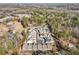 An aerial view of a community in a wooded area with a retention pond at 105 Ivey Way, Woodstock, GA 30188