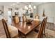 Dining room boasts hardwood floors, stylish chandelier, and access to the kitchen at 105 Ivey Way, Woodstock, GA 30188