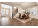 Open-concept dining room featuring a staircase and large windows for natural light at 105 Ivey Way, Woodstock, GA 30188