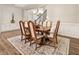 Dining room features wood floors, a light fixture, and is adjacent to the staircase at 105 Ivey Way, Woodstock, GA 30188