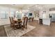 Dining room opens to the living room and boasts a chandelier and wood floors at 105 Ivey Way, Woodstock, GA 30188