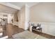 Bright foyer with wainscoting, hardwood floors, a blue accent bench, and view of staircase at 105 Ivey Way, Woodstock, GA 30188