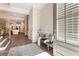 Inviting foyer features a blue accent bench, light gray rug, and view of the kitchen at 105 Ivey Way, Woodstock, GA 30188