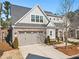 Attractive house with gray siding, brick accents, a two-car garage, and a neatly landscaped yard at 105 Ivey Way, Woodstock, GA 30188
