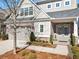Charming two-story home with a brick and gray exterior, landscaped front yard, and attached two-car garage at 105 Ivey Way, Woodstock, GA 30188