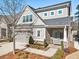Elegant two-story home with brick and siding, a well-manicured lawn, and an attached two-car garage at 105 Ivey Way, Woodstock, GA 30188
