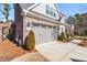 Close-up of house brick and siding with attached two-car garage at 105 Ivey Way, Woodstock, GA 30188