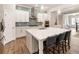 Modern kitchen features white cabinetry, an island with seating, stainless steel appliances, and tile backsplash at 105 Ivey Way, Woodstock, GA 30188