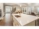 Spacious kitchen island overlooks the dining room, staircase, and living room at 105 Ivey Way, Woodstock, GA 30188