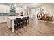 Open concept kitchen with white cabinets, stainless steel appliances, large island and adjacent dining area at 105 Ivey Way, Woodstock, GA 30188
