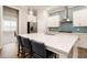 Modern kitchen with large island, stainless steel appliances, and stylish backsplash at 105 Ivey Way, Woodstock, GA 30188