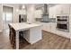 Modern kitchen with stainless steel appliances, tiled backsplash, and a large island at 105 Ivey Way, Woodstock, GA 30188