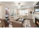 Open living room with fireplace, large windows, and plush sectional sofa for relaxing or entertaining at 105 Ivey Way, Woodstock, GA 30188