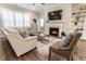 Living room featuring fireplace with decorative mantle, built-in shelving, ceiling fan and plantation shutters at 105 Ivey Way, Woodstock, GA 30188