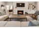 Bright living room features a fireplace, built-in shelving, hardwood floors, and comfortable furniture at 105 Ivey Way, Woodstock, GA 30188