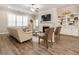 Cozy living room with fireplace, built-in shelving, ceiling fan and large windows with plantation shutters at 105 Ivey Way, Woodstock, GA 30188