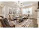Bright living room featuring a large sectional sofa, modern rug, and plantation shutters at 105 Ivey Way, Woodstock, GA 30188