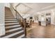Open-concept home features dark-stained wood staircase, vaulted ceiling, and gourmet kitchen with stainless appliances at 105 Ivey Way, Woodstock, GA 30188