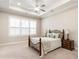 Relaxing main bedroom with tray ceiling, plantation shutters, and comfortable bed at 105 Ivey Way, Woodstock, GA 30188