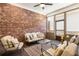 Charming sunroom with exposed brick wall and comfortable seating area at 105 Ivey Way, Woodstock, GA 30188