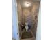 Bathroom featuring a toilet, patterned wallpaper, and a storage rack at 165 Shiver Blvd, Covington, GA 30016