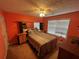 Cozy bedroom featuring a bed with a colorful comforter, bedside tables, and a window at 165 Shiver Blvd, Covington, GA 30016