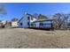 Exterior view of the back of the home from the lakefront backyard featuring a deck and access to the lake at 2762 Inverloch Cir, Duluth, GA 30096