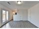 Light-filled living room shows wood-look floors, recessed lighting, and door to deck at 2762 Inverloch Cir, Duluth, GA 30096