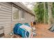 Exterior shot of a home's backyard, showing the side of the house and a yard area with foliage at 5461 Chuzzlewit Sw Ct, Lilburn, GA 30047