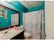 Bathroom featuring a single sink vanity and shower with blue walls at 5461 Chuzzlewit Sw Ct, Lilburn, GA 30047