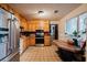 Traditional kitchen featuring stainless steel appliances, wood cabinets, and tile flooring at 5461 Chuzzlewit Sw Ct, Lilburn, GA 30047