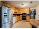 Functional kitchen featuring stainless steel appliances, light wood cabinets, and tile flooring at 5461 Chuzzlewit Sw Ct, Lilburn, GA 30047