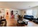 Laminate floored living room leading to a back door, as well as a fireplace and view of the hallway at 5461 Chuzzlewit Sw Ct, Lilburn, GA 30047
