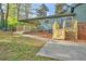 View of the home's backyard with new decks and patio area, surrounded by mature trees at 7546 Palmetto Way, Riverdale, GA 30274