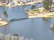 An aerial view showcasing lake with foot bridge, golf course, and surrounding trees at 3000 Shade Tree Ct, Villa Rica, GA 30180