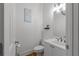 This bathroom features a decorative sign, toilet, vanity, and a shelf with a plant and other decorations at 3000 Shade Tree Ct, Villa Rica, GA 30180