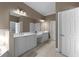 This primary bathroom boasts double sinks, vanity, and white cabinets for ample storage at 3000 Shade Tree Ct, Villa Rica, GA 30180
