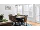 A dining area with hardwood floors, a modern table, and windows that let in natural light at 3000 Shade Tree Ct, Villa Rica, GA 30180