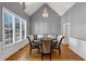 Bright dining room with a vaulted ceiling, hardwood floors, and a stylish table under a chandelier at 3000 Shade Tree Ct, Villa Rica, GA 30180
