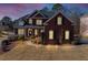 Charming brick home featuring a well-manicured lawn and a welcoming entrance at dusk at 3000 Shade Tree Ct, Villa Rica, GA 30180