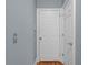 Hallway features a white door, neutral walls, and hardwood flooring at 3000 Shade Tree Ct, Villa Rica, GA 30180