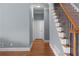Hallway with hardwood floors, stairs with iron spindles, and neutral paint color at 3000 Shade Tree Ct, Villa Rica, GA 30180