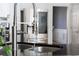 Close-up of kitchen sink, granite countertops, and stainless steel appliances at 3000 Shade Tree Ct, Villa Rica, GA 30180