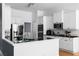 Well-lit kitchen boasts stainless steel appliances, black countertops, and white cabinets at 3000 Shade Tree Ct, Villa Rica, GA 30180