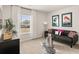 Cozy living room with contemporary decor, stylish sofa, and a window with natural light at 107 Hill Side Ln, Dallas, GA 30157